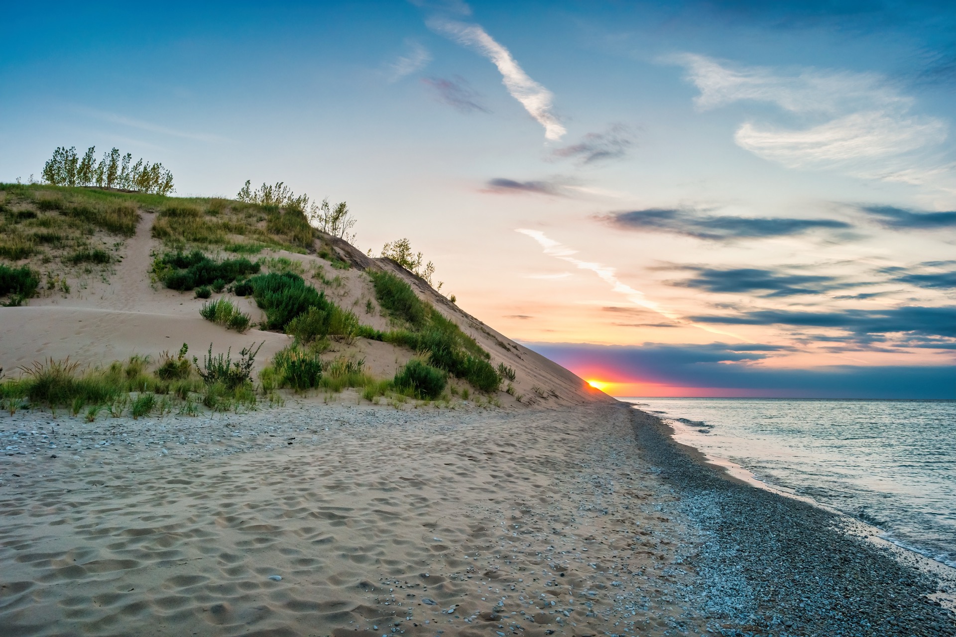 Sleeping Bear Dunes at sunset — sand, dune grass, and Lake Michigan