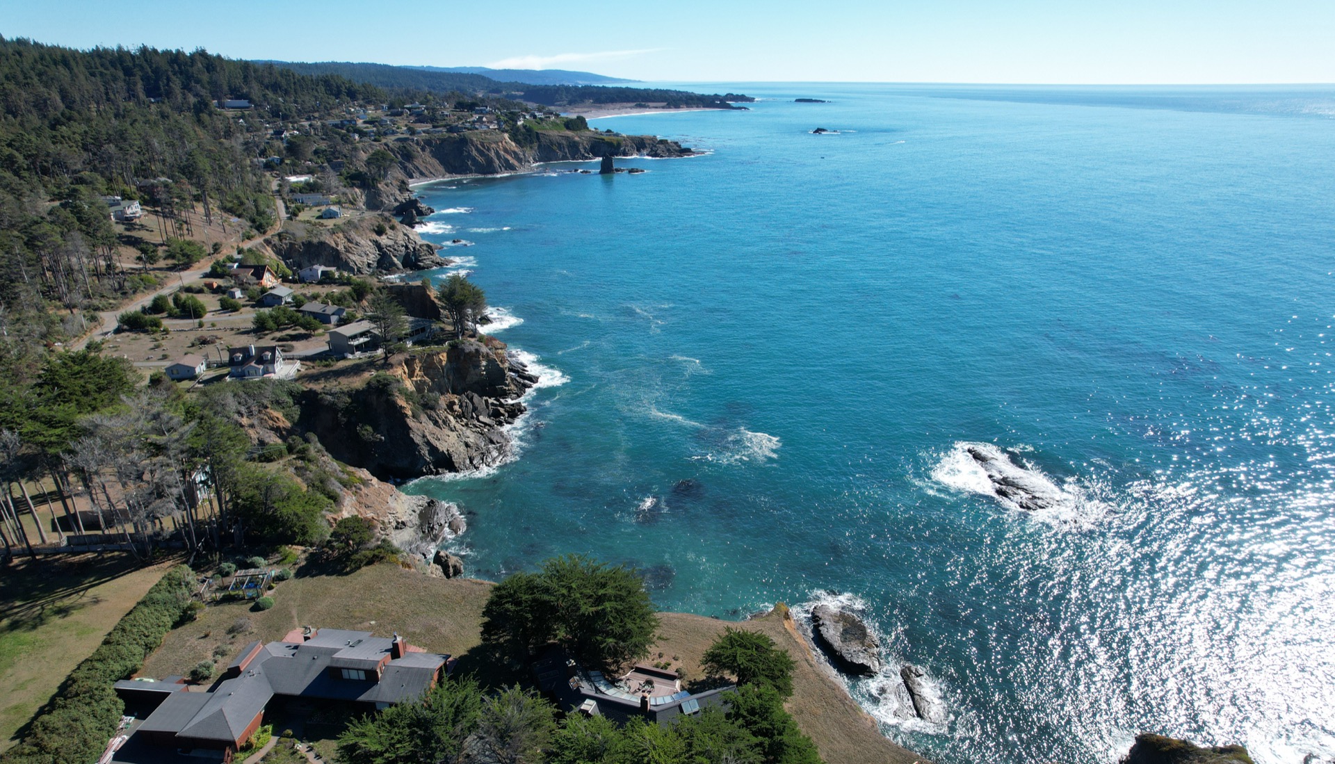 Aerial view of the rugged coastline and bluff-top houses on the Saltbluff headland